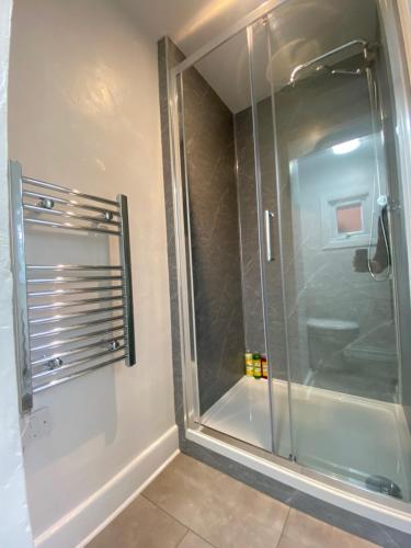 a shower with a glass door in a bathroom at Perfect For Long Stays With Driveway Parking in Southampton