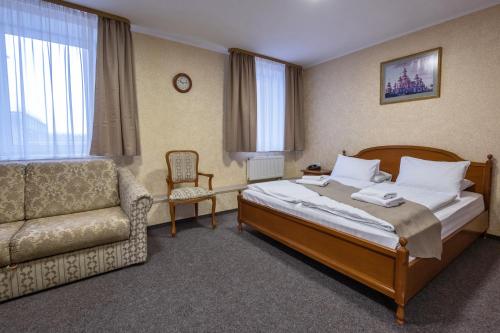 een hotelkamer met een bed en een bank bij Hotel Express Корпус 2 in Kiev