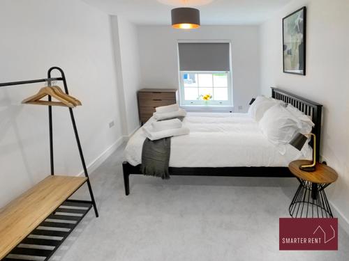 a white bedroom with a bed and a window at Eton, Windsor - 1 Bedroom Ground Floor Apartment - With Parking in Eton