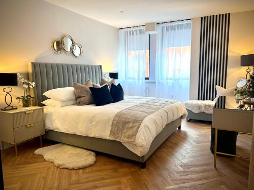 a bedroom with a large bed and a mirror at Romantic Royal Windsor in Windsor