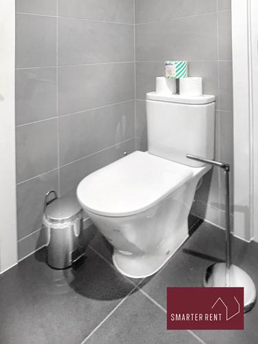 a bathroom with a white toilet and a trash can at Eton Windsor - 1 Bedroom Flat - With Parking in Eton