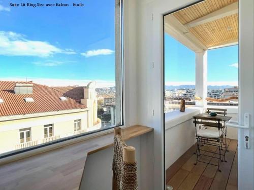 a balcony with a desk and a view of a building at LaFrenchCasa Clandestina in Marseille