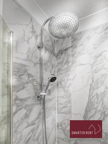 a shower with a glass door and a sign that says smarter rent at Yateley - Spacious 2 Bedroom House in Finchampstead