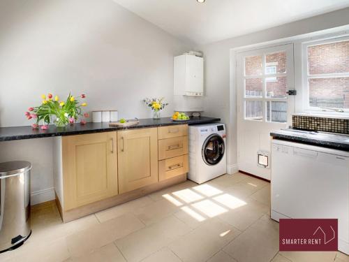 a kitchen with a washer and a washing machine at Ascot - Immaculate 2 bed House with parking in Ascot