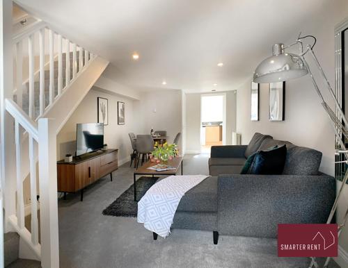 a living room with a couch and a staircase at Ascot - Immaculate 2 bed House with parking in Ascot