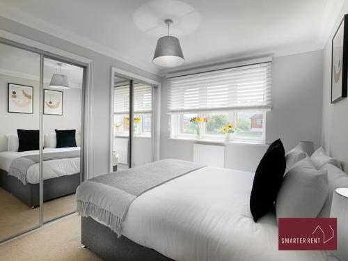 a bedroom with two beds and a window at Wokingham - 2 Bedroom Ground Floor Flat - With Parking in Wokingham