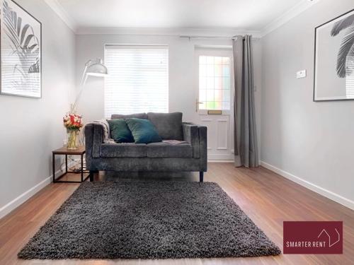 a living room with a couch and a rug at Lightwater - Immaculate 1 Bedroom House in Bagshot