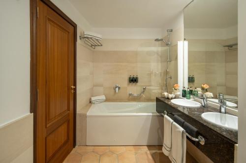 a bathroom with a tub and a sink at Melia Cala d'Or Boutique Hotel in Cala d´Or