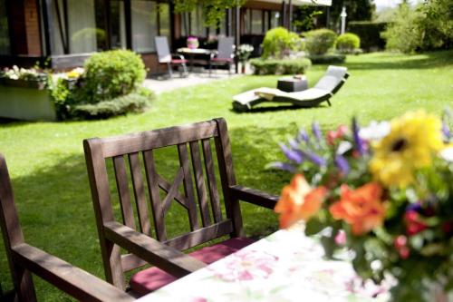 - une table et des chaises dans une cour fleurie dans l'établissement Ferienhaus am Mattenweg, à Hinterzarten