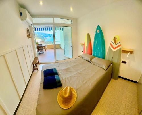 a bedroom with a bed and surfboards on the wall at Chalana I, Cala Salions, Tossa de Mar in Cañet de Mar