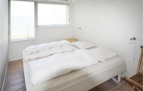a white bedroom with two beds with white sheets at Nice Home In Assens With Kitchen in Assens