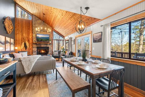 a living room with a table and a couch at The Family Stone Luxe Cabin Sleeps 12 Hot tub Dogfriendly Dollywood in Pigeon Forge