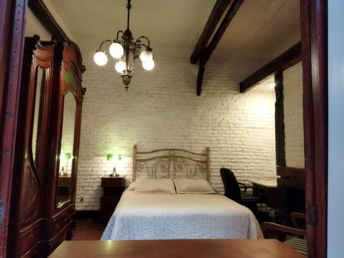 een slaapkamer met een bed en een kroonluchter bij Galeón Nouveau (Apt 02). Terrace in The Oldtown in Montevideo