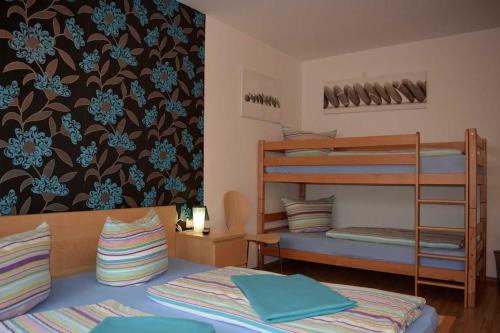 a room with two bunk beds and a bed at Gästehaus Luna in Rust