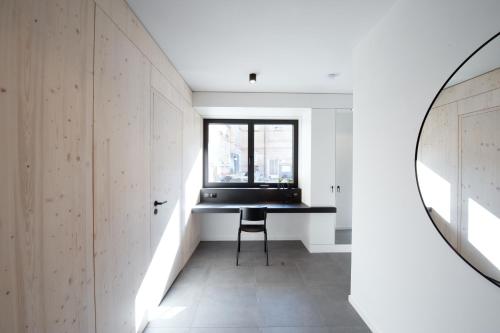 a room with a table and a mirror at Mono Design Apartments in Stuttgart