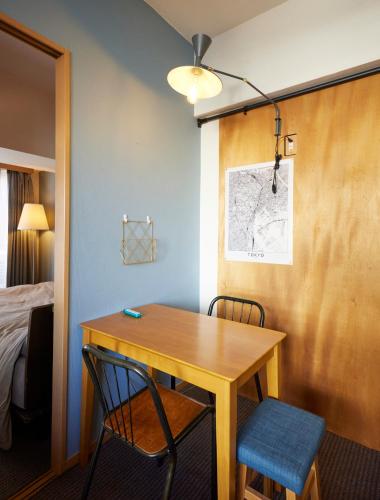 a room with a table and two chairs and a bed at Shibuya apartment SHINSEN in Tokyo