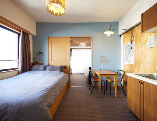 a hotel room with a bed and a table at Shibuya apartment SHINSEN in Tokyo
