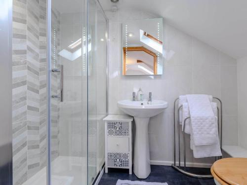 a white bathroom with a sink and a shower at 1 Bed in Abergavenny BN092 in Llanvetherine
