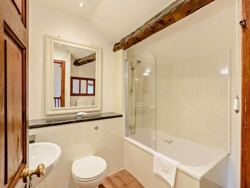 a bathroom with a toilet and a shower and a sink at 1 Bed in Crosthwaite LCC70 in Crosthwaite