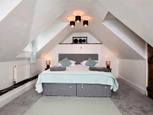 a bedroom with a large bed in a attic at 1 Bed in Great Torrington ANNAS in Langtree