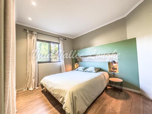 a bedroom with a large bed and a window at Villa Talasani in Talasani