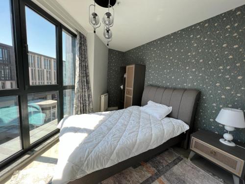 a bedroom with a bed and a large window at E5 Deluxe in Istanbul