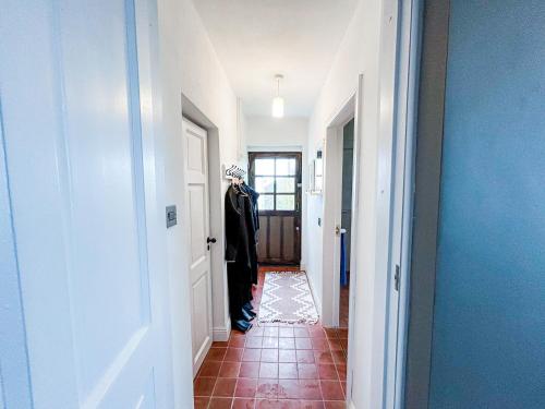 a hallway with a mannequin standing in a hallway at Ballylusky Holiday Home by Trident Holiday Homes in Ballydavid