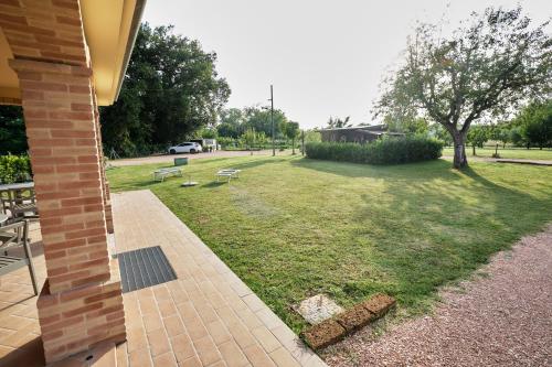 a park with benches and a field of grass at La Casina di Ely B&B in SantʼAndrea in Casale