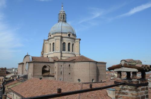 a church with a tower on top of a roof at Abbazia Bed & Breakfast, MantegnaHotels in Mantova