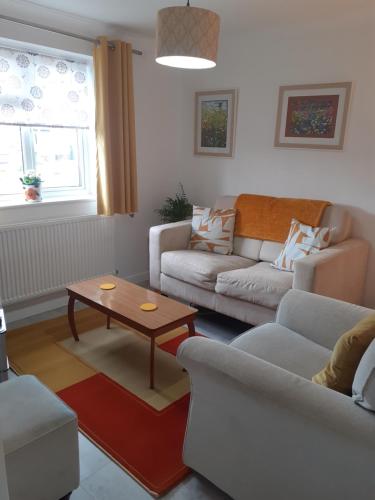 a living room with two couches and a coffee table at 2 bed bungalow in Peacehaven