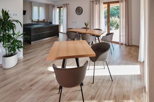 a room with tables and chairs and a piano at La Casina di Ely B&B in SantʼAndrea in Casale