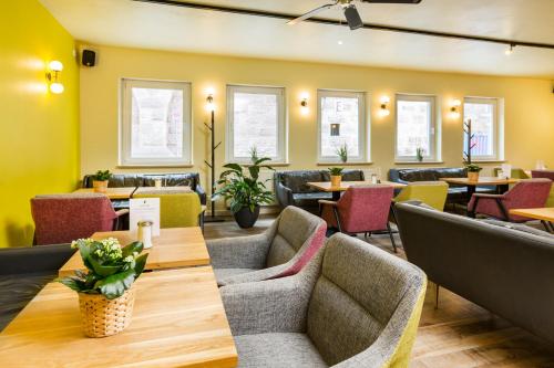 a dining room with tables and chairs and tablesktop at Five Reasons Hostel & Hotel in Nürnberg