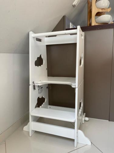 a white refrigerator with an apple on the side of it at InselSuites FinkenNest Airbus Finkenkwerder 125 m2 Kamin in Hamburg