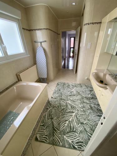 a bathroom with a zebra print carpet in the floor at Maison malouine proche de plage in Dunkerque