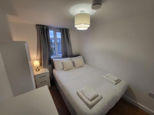 a small bedroom with a bed and a window at Central 5BR Retreat - Walk to Tube, Explore London in London