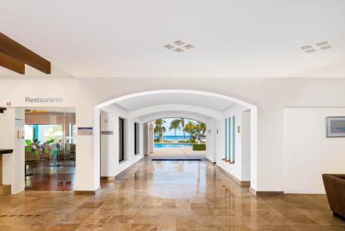 an empty hallway with an archway in a building at Beachscape Kin Ha Villas & Suites in Cancún