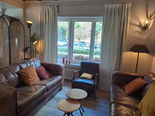 a living room with a couch and a table at Auberge De La Gaichel in Gaichel