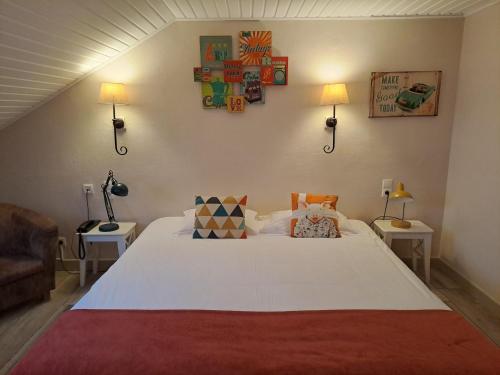 a bedroom with a large white bed with two tables at Auberge De La Gaichel in Gaichel