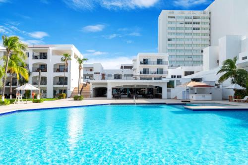 a large swimming pool in front of a building at Beachscape Kin Ha Villas & Suites in Cancún