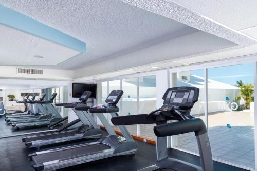 a gym with a row of treadmills and elliptical machines at Beachscape Kin Ha Villas & Suites in Cancún