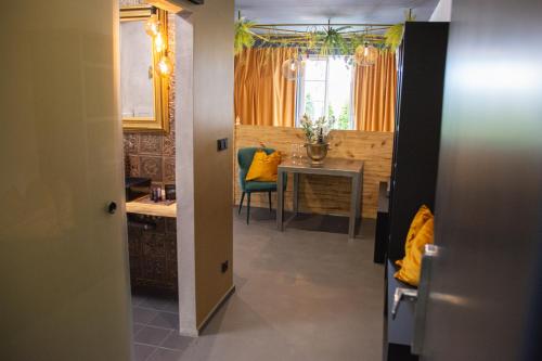 a hallway with a table and a dining room at Royal Apartmány in Dobříš