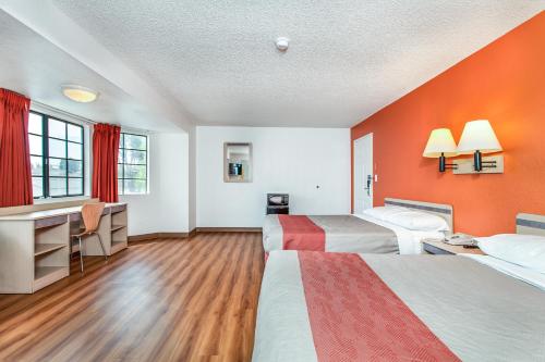 a hotel room with two beds and a desk at Motel 6-Fairfield, CA - North in Fairfield