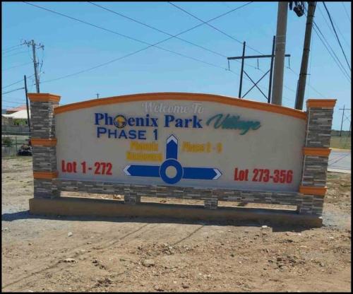 a sign for a phoenix park phase at Gated Cozy Urban Luxe Retreat in Portmore
