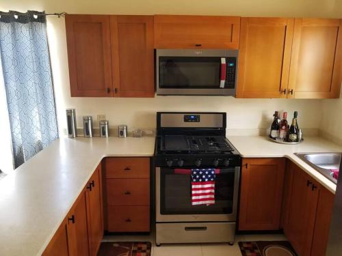 a kitchen with a stove with an american flag on it at Gated Cozy Urban Luxe Retreat in Portmore