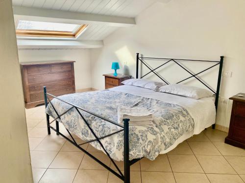 a bedroom with a large bed with a black frame at Delizioso appartamento in centro! in Fano