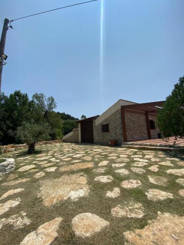 a large yard with rocks in front of a building at Fattoria F.lli Marsolo in Chiusa Sclafani