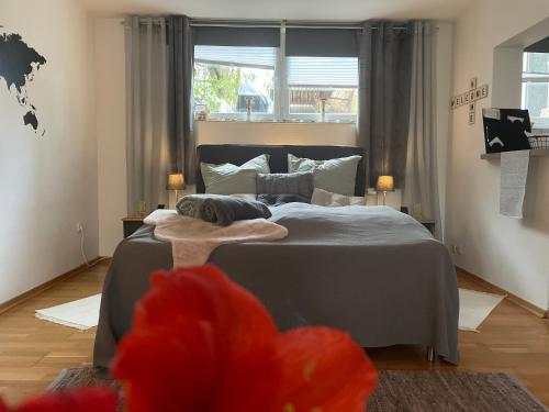 a bedroom with a bed and a large window at Modernes Appartement im Grünen in Cologne