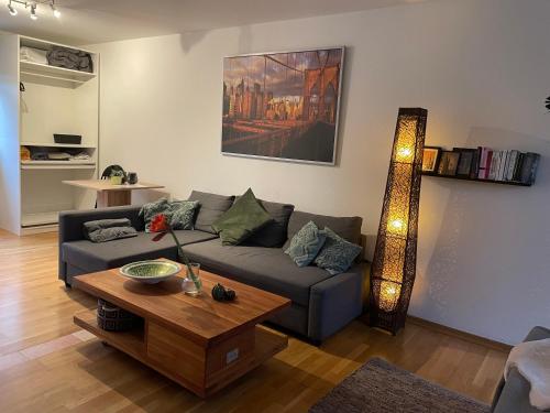 a living room with a couch and a table at Modernes Appartement im Grünen in Cologne