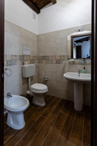 a bathroom with a toilet and a sink at Fattoria F.lli Marsolo in Chiusa Sclafani