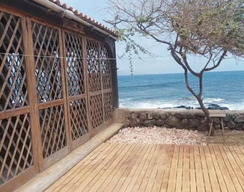 a wooden porch with the ocean in the background at L2B - São Vicente in Mindelo